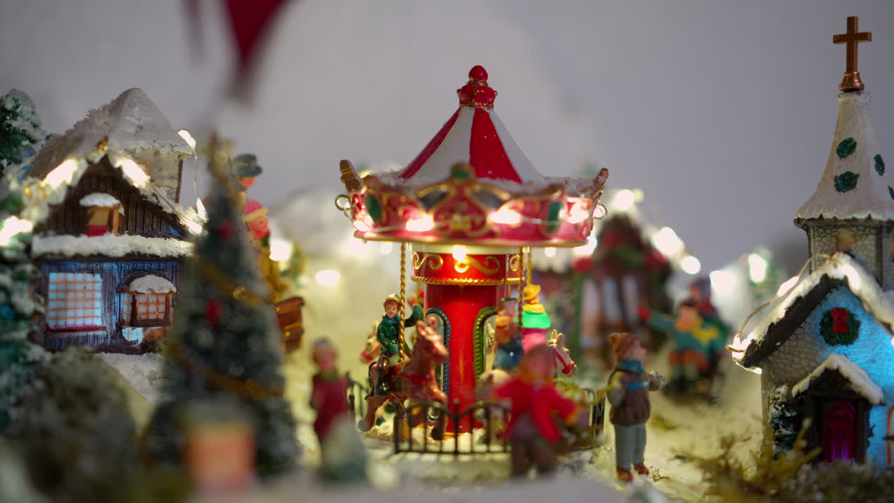 Miniature Christmas Village with Rotating Carousel and Festive Lights