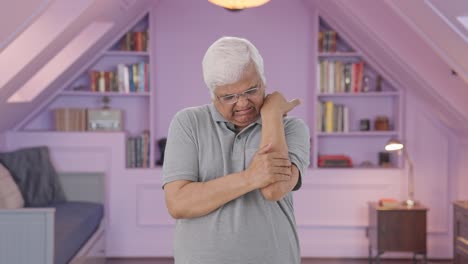 sick indian old man suffering from arthritis