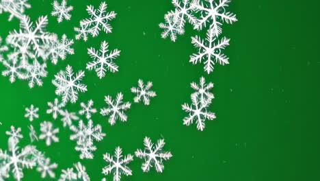 copos de nieve cayendo sobre un fondo verde