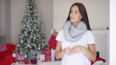 Friendly-young-woman-celebrating-Xmas-at-home