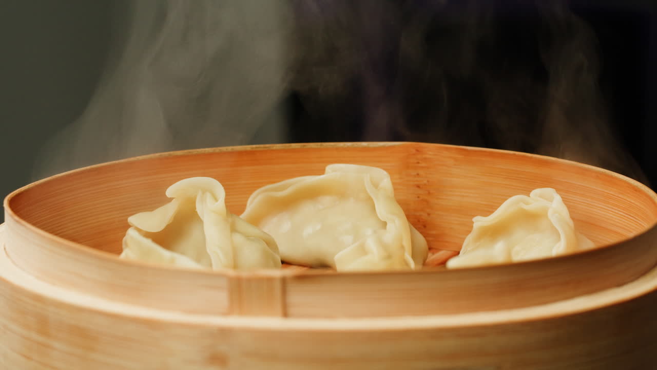 Hot Steaming Dumplings in a Bamboo Steamer Basket