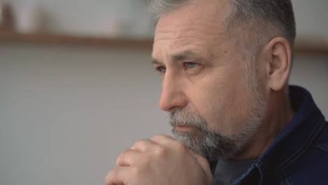 Portrait-Of-Mature-Man-Serious,-Worried,-Thinking-And-Praying-Indoors-At-Home