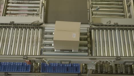 cardboard box moving on a conveyor belt in a factory