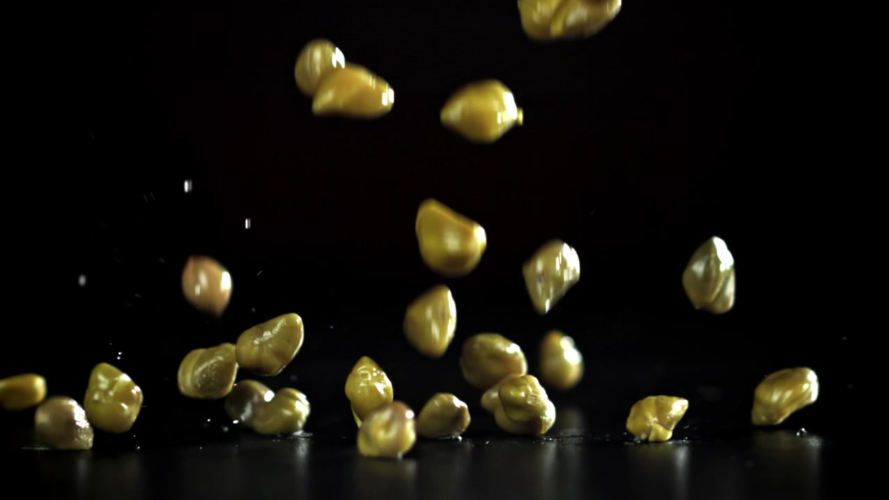 Movimento rallentato di capperi che cadono su uno sfondo nero
