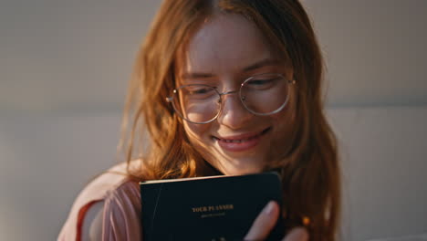 closeup inspired girl resting home in sunlight. smiling dreamy teenager holding