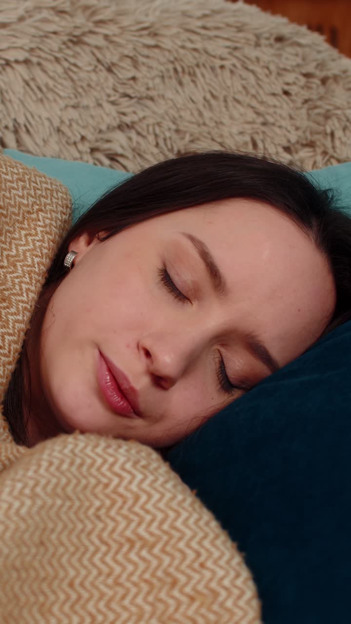 Woman waking up terrified on sofa after nightmare breathing heavily scared stressed disoriented