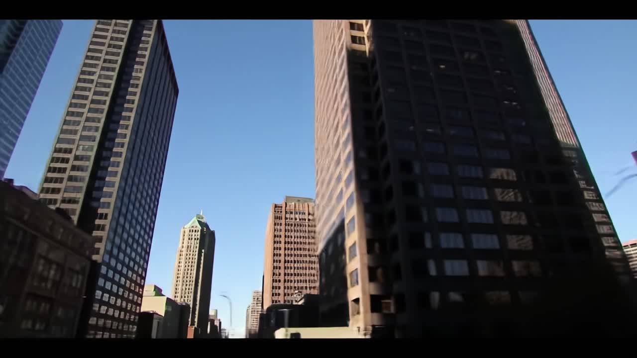 A Stunning View of Urban Architecture: Captivating Skyscrapers Against a Clear Blue Sky in a Dynamic City Skyline Setting