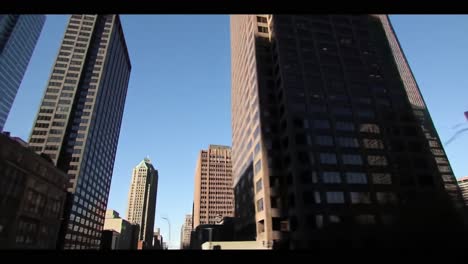 a stunning view of urban architecture: captivating skyscrapers against a clear blue sky in a dynamic city skyline setting