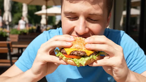 young man ready to devour a delicious cheeseburger