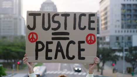 shot of a unrecognizable woman protesting outside