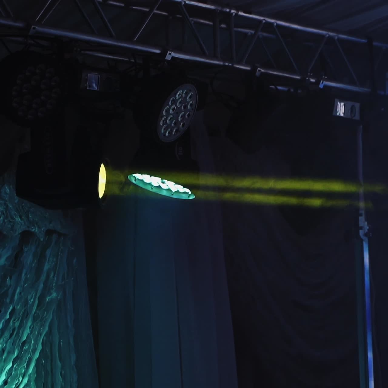 Musical farm on the stage. Bright spotlights turning and shimmering with different colors in the dark night club.