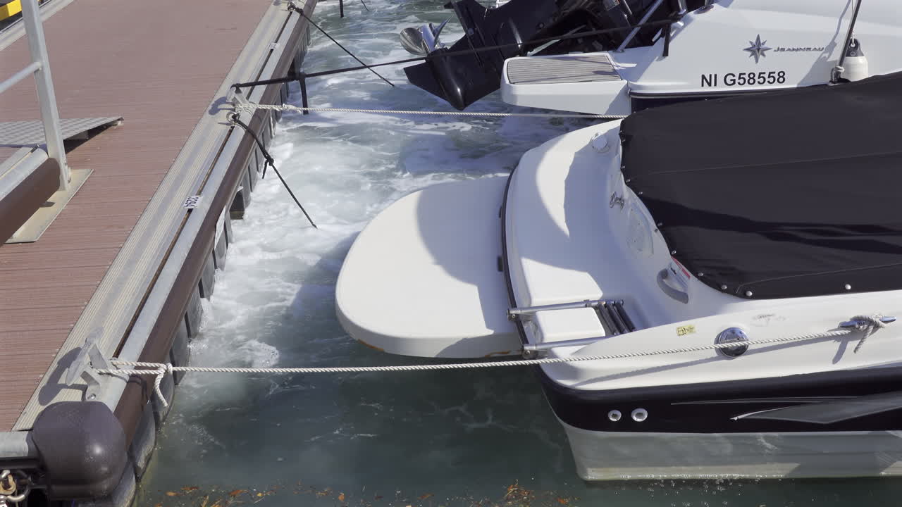 Antibes, France - May 20, 2025: White boats docked in dirty water in Port Vauban
