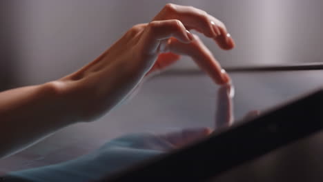 close-up of a hand interacting with a digital tablet