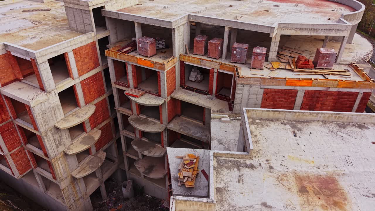 Construction site of a large unfinished building in an urban area