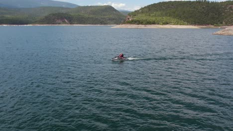 two people on waverunner jet ski at flaming gorge reservoir, aerial