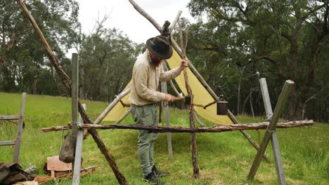 australian bush settler building a pioneer style hut in the forest