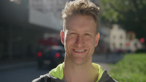 portrait confident young man smiling happy enjoying successful urban lifestyle travel in city street on sunny day slow motion
