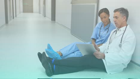 animation of caucasian male doctor with tablet talking with nurse on floor