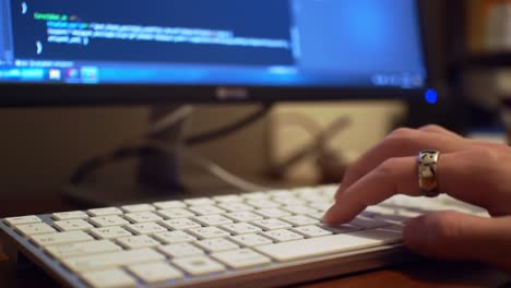 focused on coding: a close-up view of hands typing on a keyboard with code displayed on a screen, capturing the essence of programming and tech collaboration