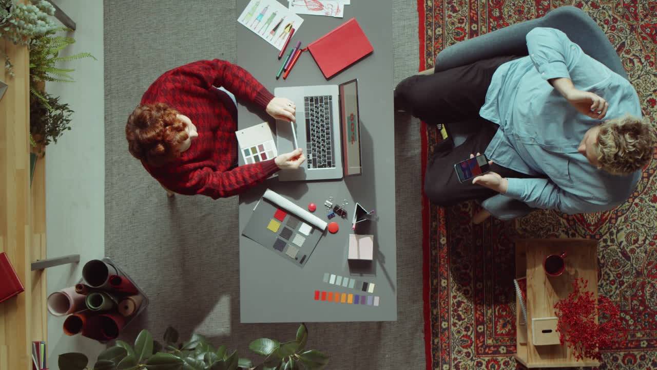 Two Designers Discussing Project in Office