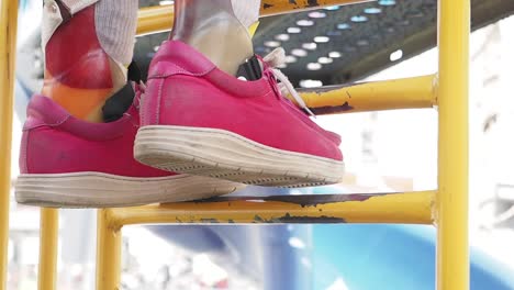 child with prosthetic leg climbing playground ladder