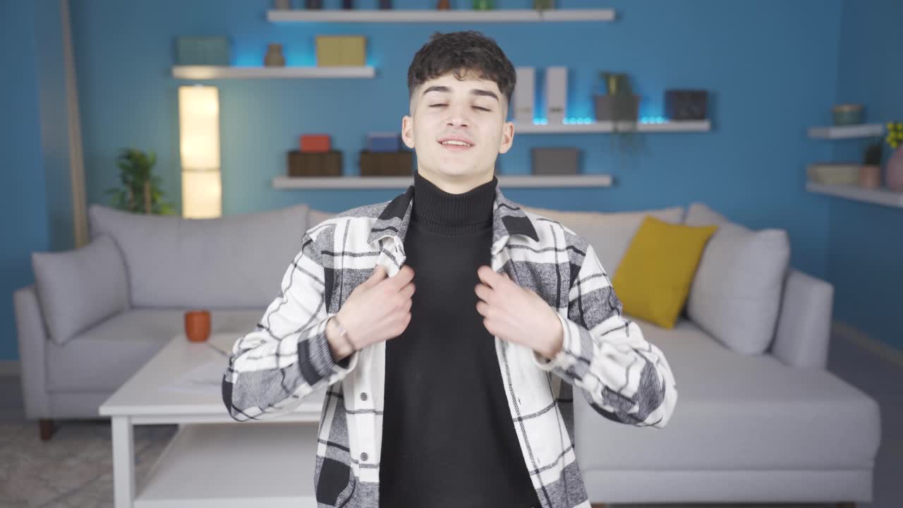 매력적이고 공감력 있는 젊은이가 카메라를 카리스마적으로 쳐다보고 있습니다.