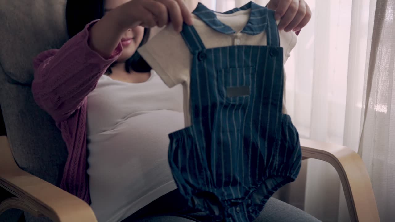 Happy pregnant woman and expecting baby at home.