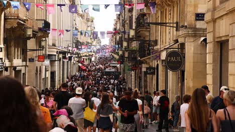 crowded street scene with people and shops