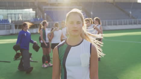 female hockey players smiling and looking at camera