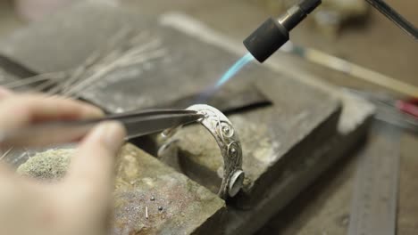 jeweler at work in jewelry. desktop for craft jewelry making with professional tools. close up view of tools. thailand.