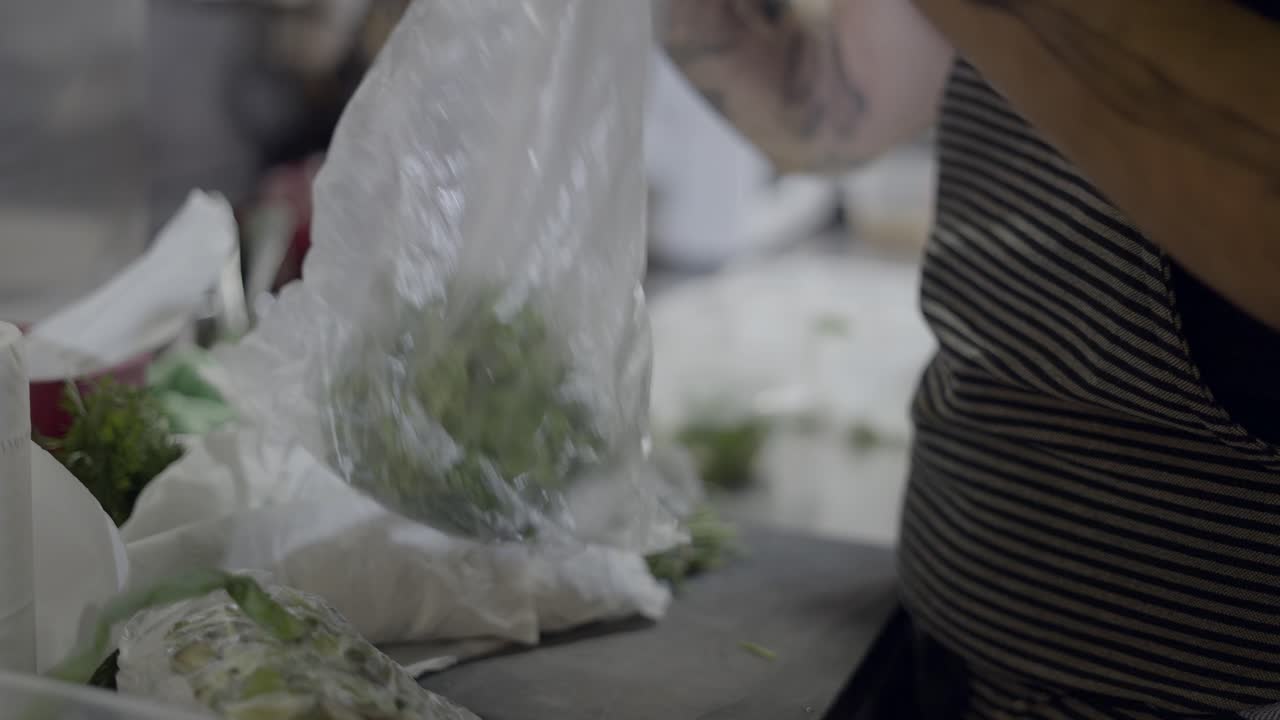 Chef preparing herbs in a kitchen