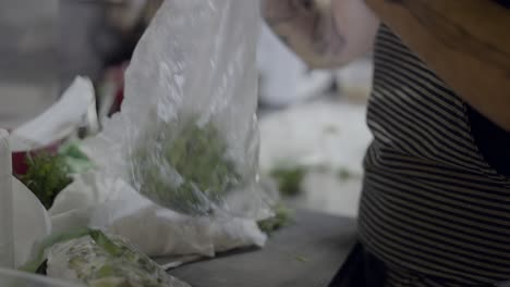 chef preparing herbs in a kitchen