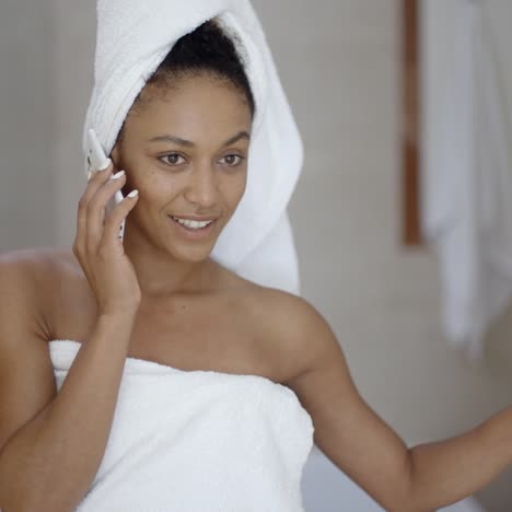 attractive young woman using phone in bathroom