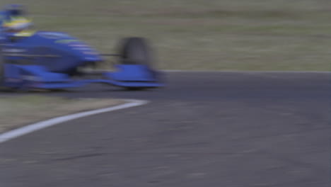 a race car speeds between two turns on a track