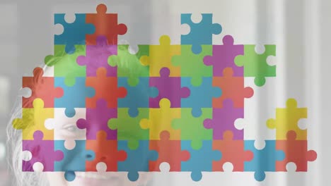 Animation-of-multicolored-connected-puzzle-pieces-over-happy-diverse-children-in-background