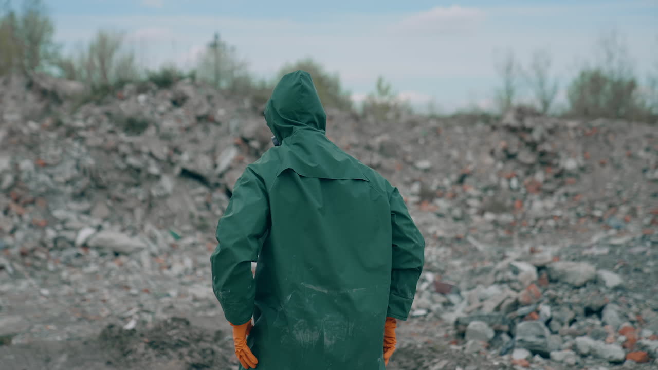 Man dancing in radioactive suit in abandoned city. Apocalyptic concept architecture.
