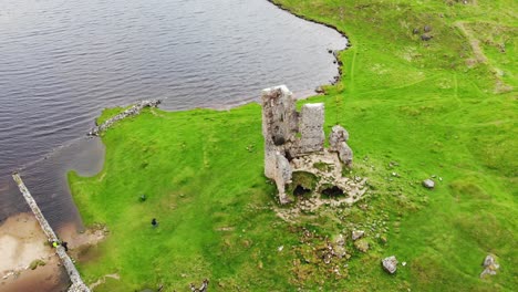 aerial overhead shot of ardvreck castle ruins in the scottish highlands