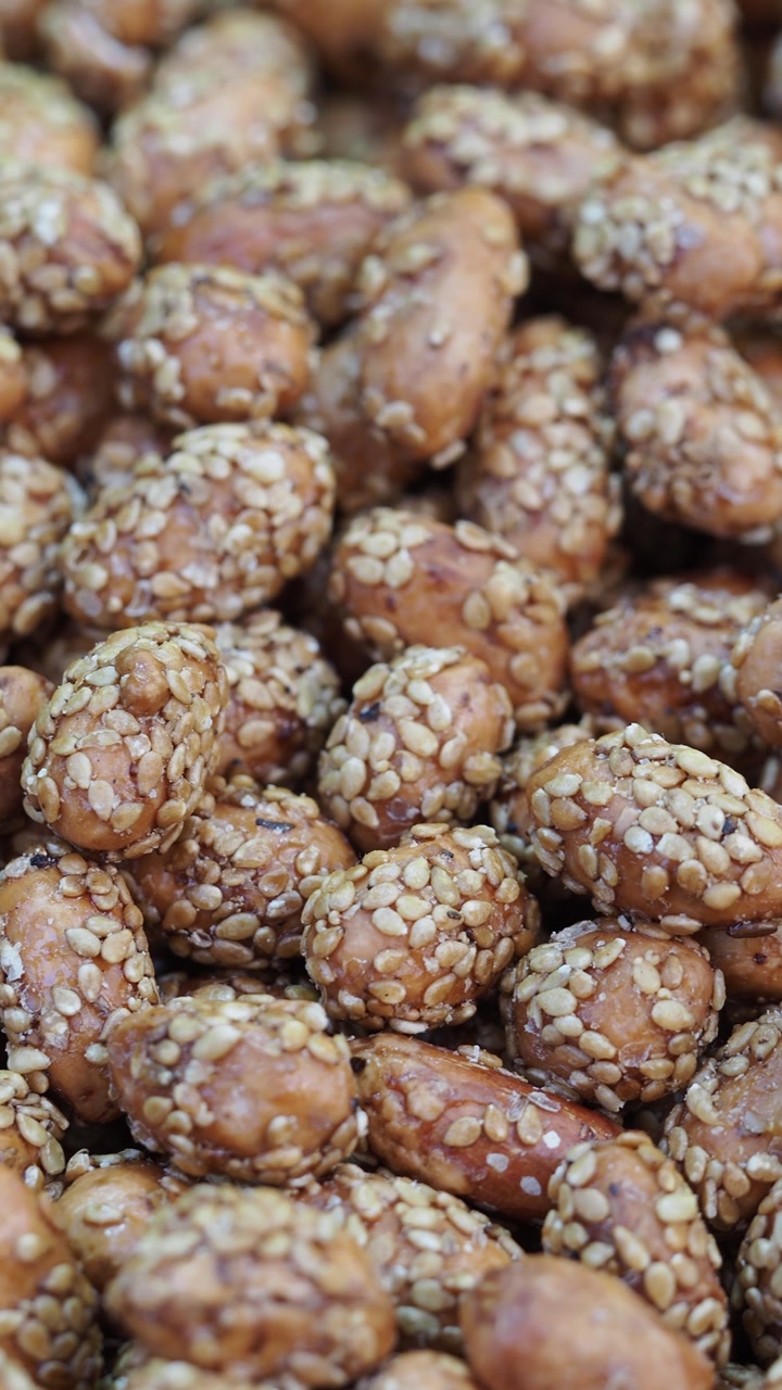 Close-Up of Sweet Glazed Peanuts Coated with Sesame Seeds