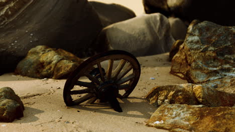 vieille roue de chariot en bois sur la plage de sable