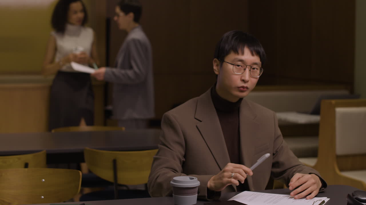 An Asian businessman is reviewing documents in the office