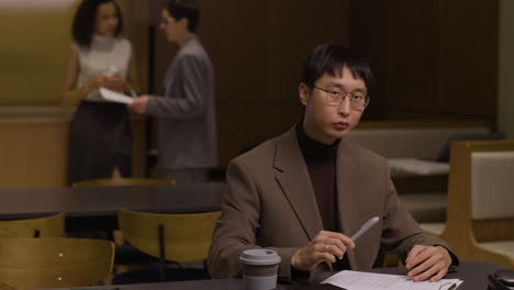 an asian businessman is reviewing documents in the office