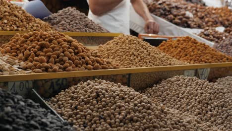 variety of dried nuts and seeds at a market