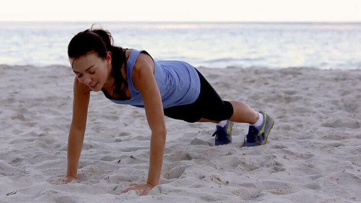 Woman exercising on the beach