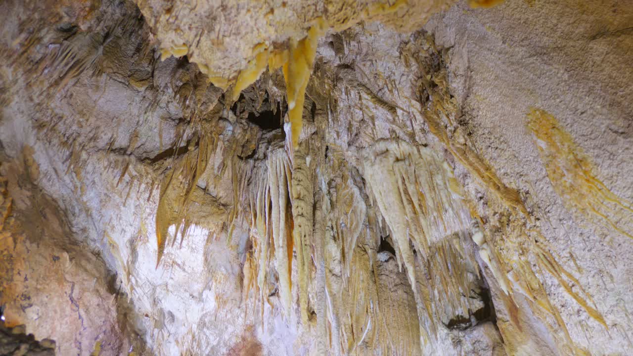 Stalactites And Stalagmites Inside The Karst Caves. Low Angle Shot