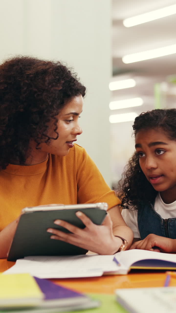 Woman and Young Girl Learning Together with a Digital Tablet