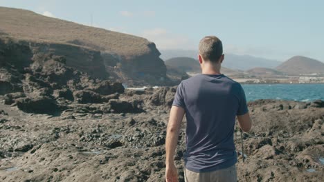 male traveler walking near blowhole