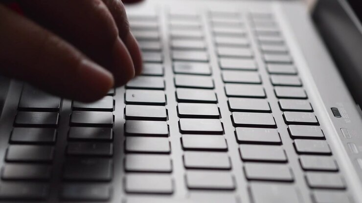 Close-up of Hands Typing on a Laptop Keyboard