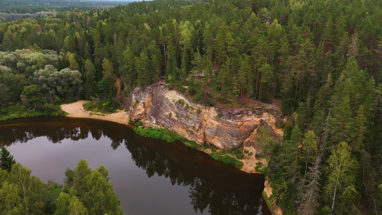 Deep river and geological site with woodland, aerial drone view