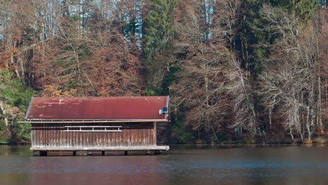 still shot of a wooden cabin in a lake in bavaria