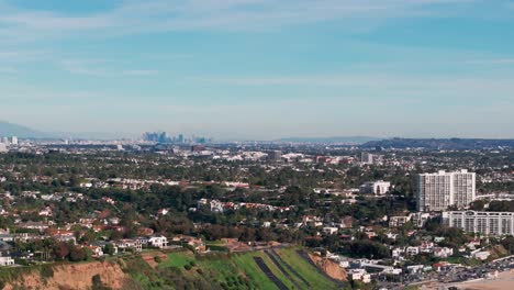 drone shot of santa monica, california with los angeles in the distance